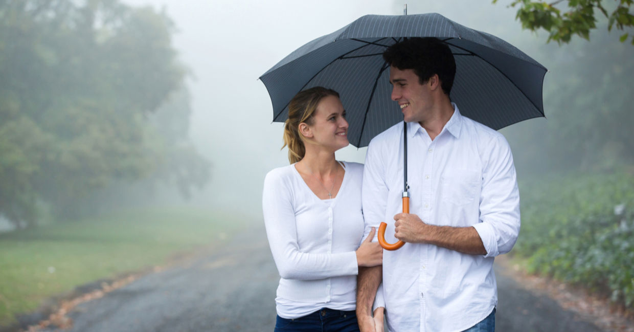 A happy couple under an umbrella