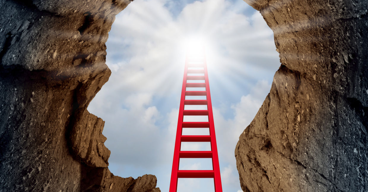 Spiritual discovery is depicted as a ladder leading up and beyond a cliff in the form of a human head.