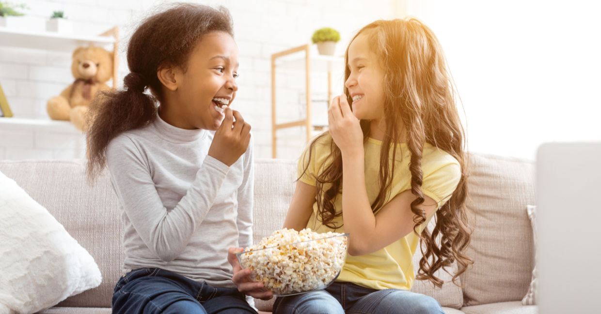 best friends snacking on popcorn.