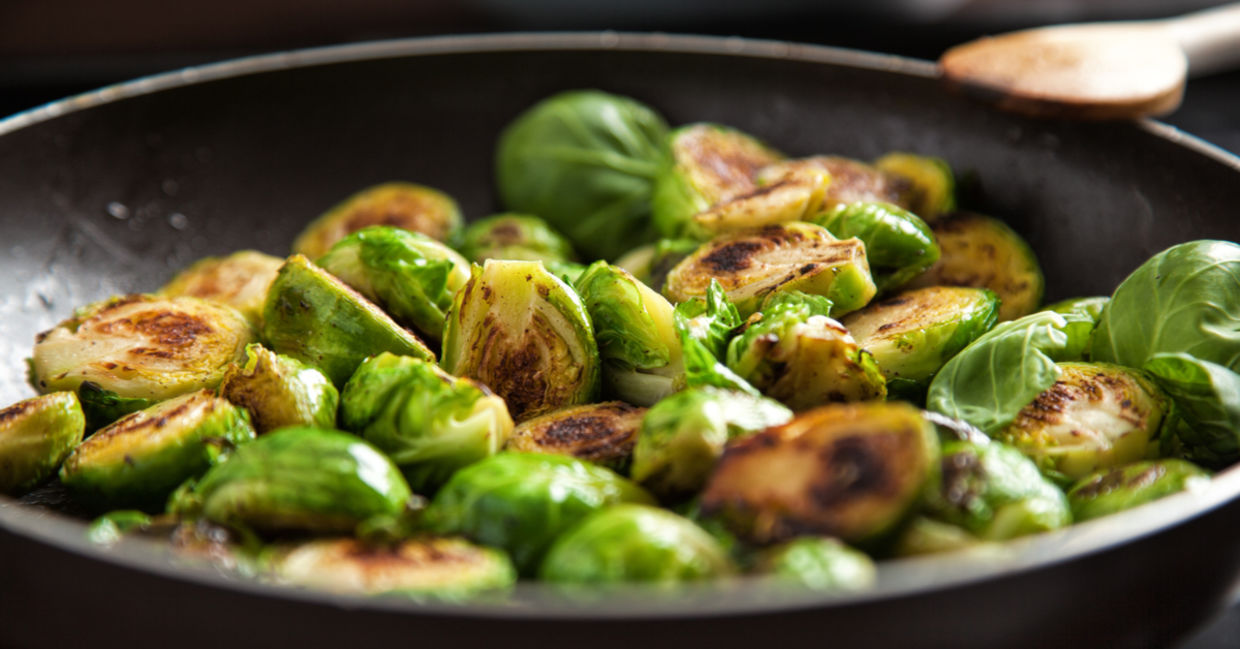 Sauteed brussels sprouts in a pan.