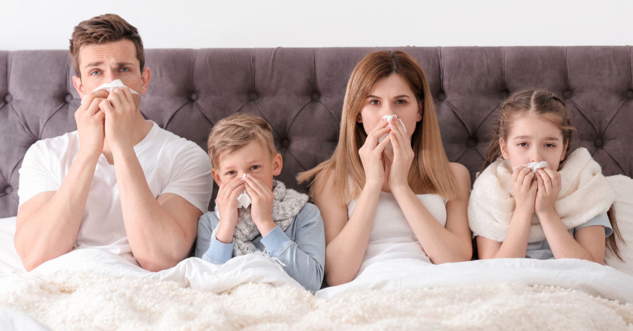 Parents and children in bed with a cold.