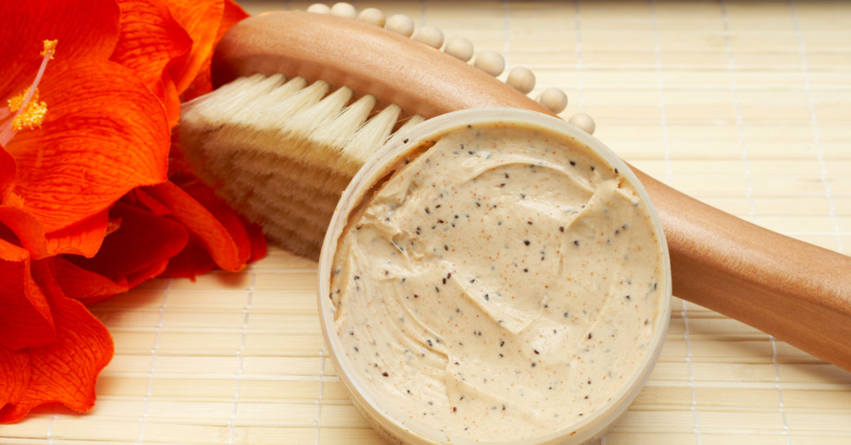 Exfoliating scrub beside a brush massager.