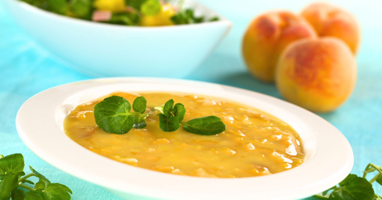 Cold peach soup garnished with watercress.