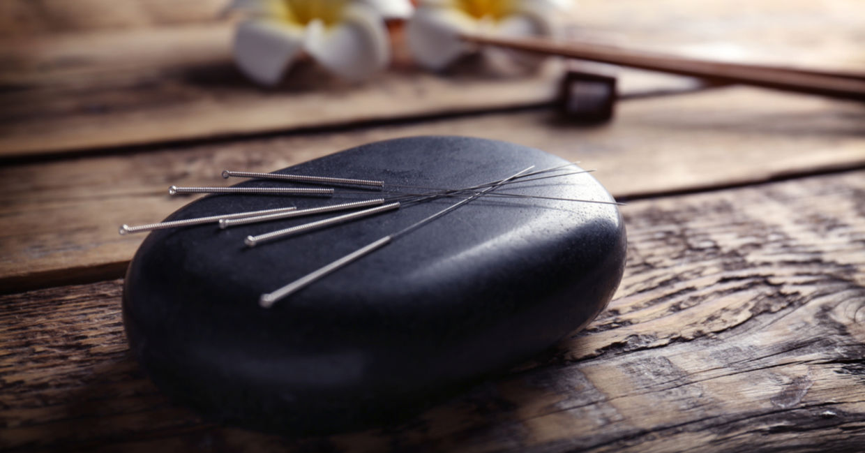 Acupuncture needles and stone.