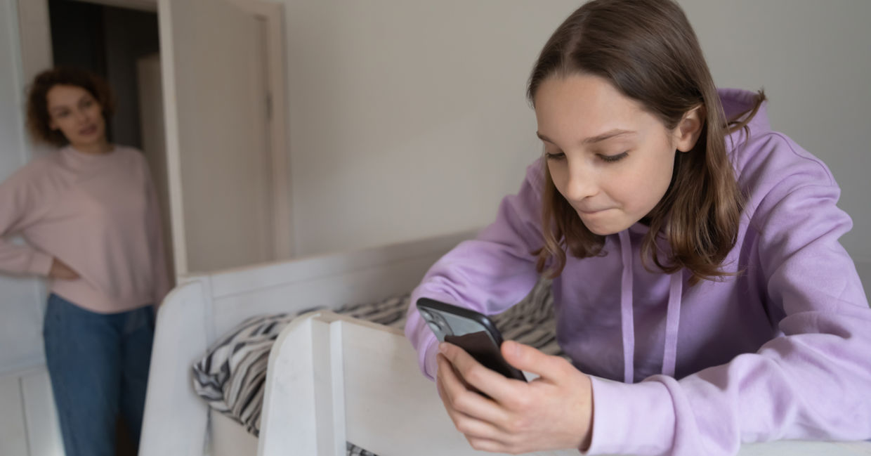 Mother lecturing teenage daughter for long smartphone use