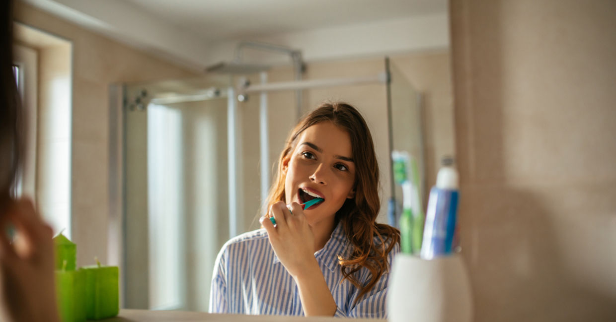 Young woman brushing her teeth