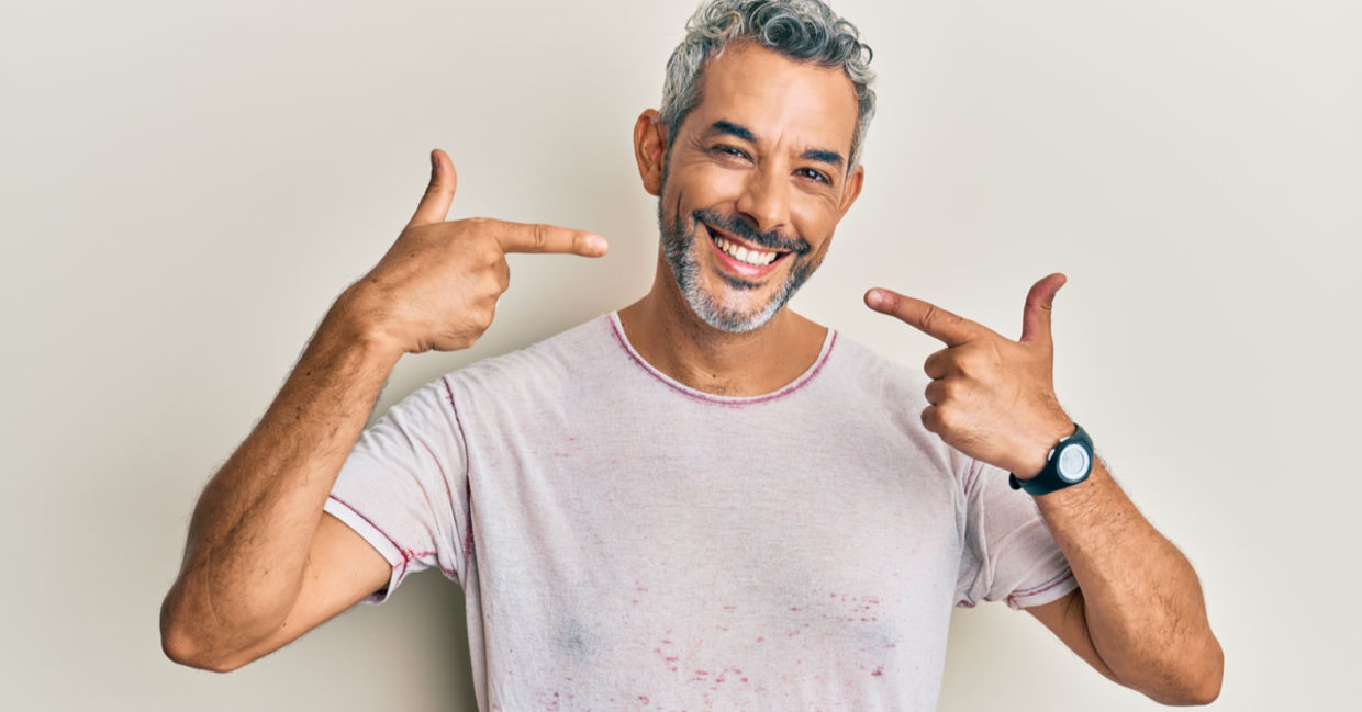 Middle aged man cheerfully showing his whiter teeth