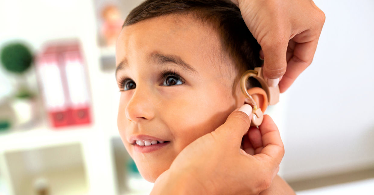 Boy being fitted for a hearing aid.