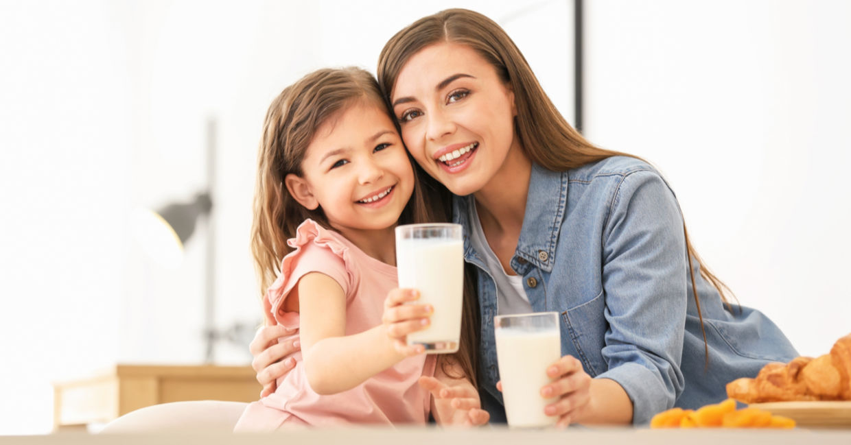 a mother and daughter enjoying vegan milk.