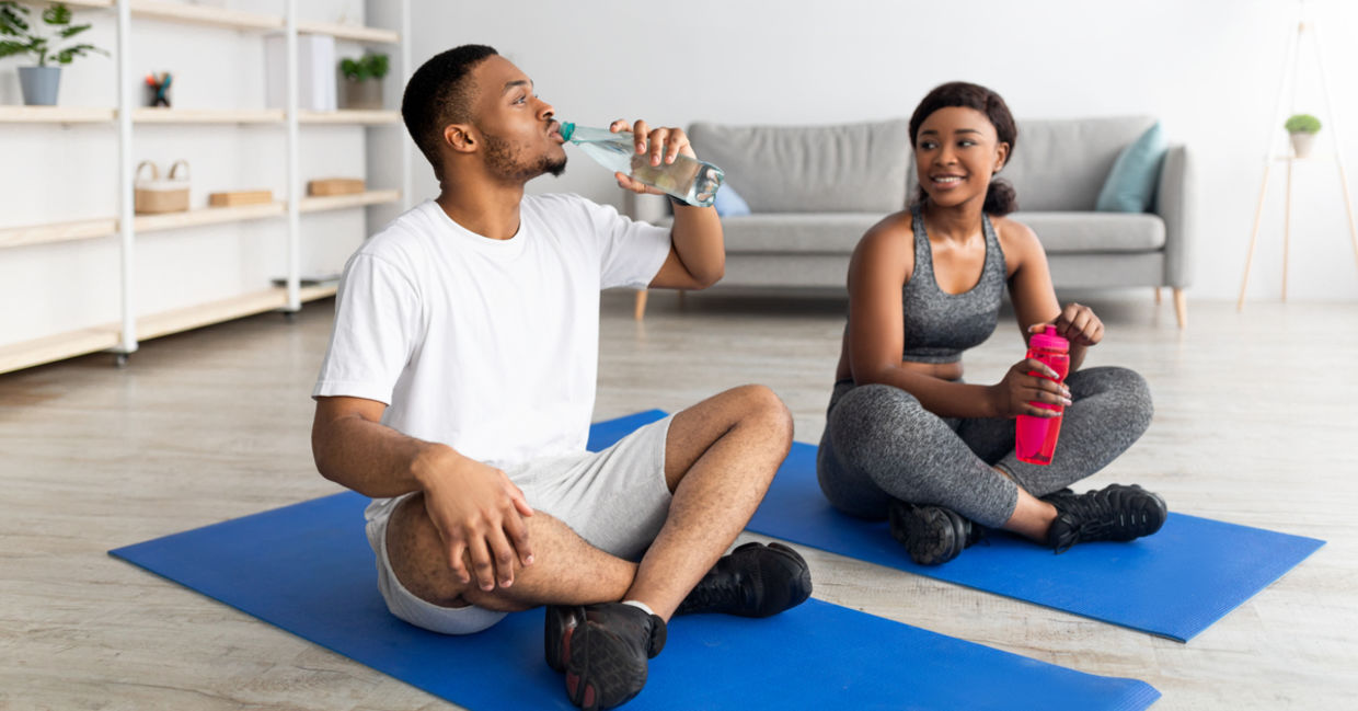 Couple staying hydrated before exercising as a part of daily eye care.