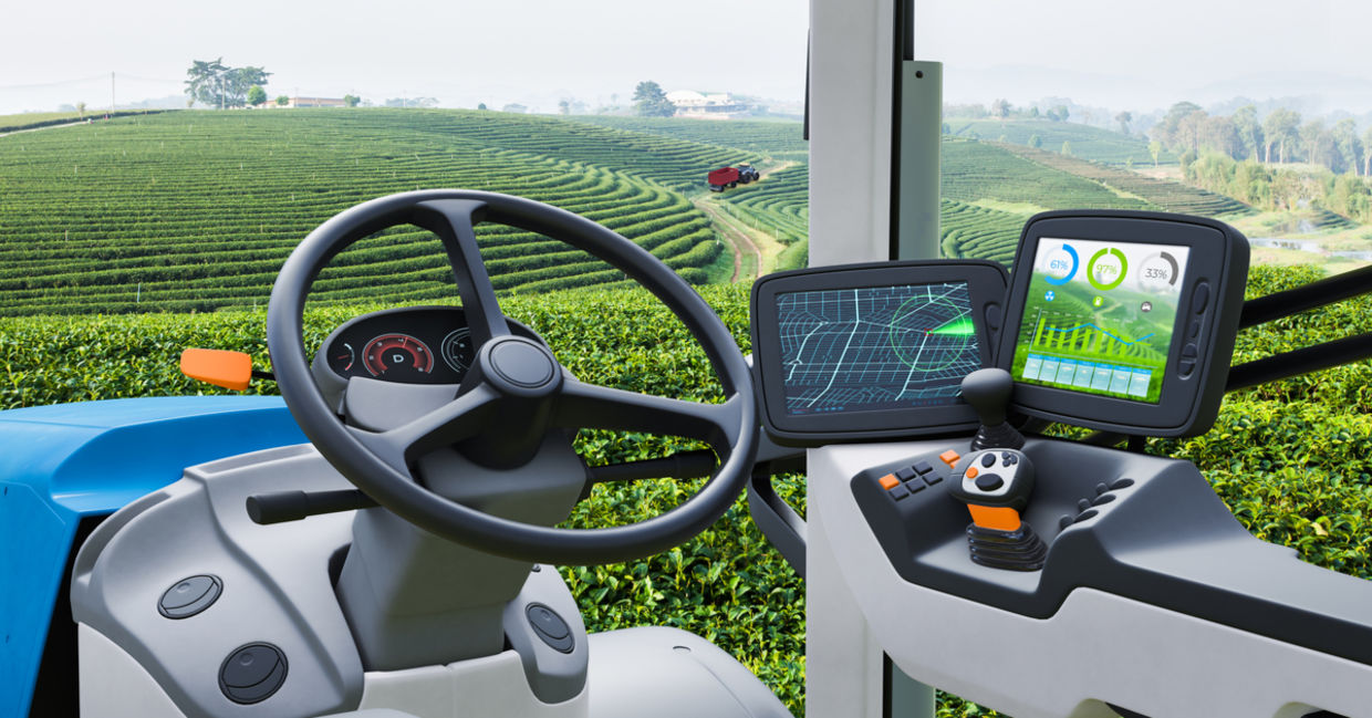 Autonomous tractor working in a green tea field.