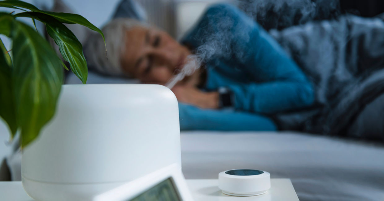 Woman sleeping in bedroom with a humidifier working.