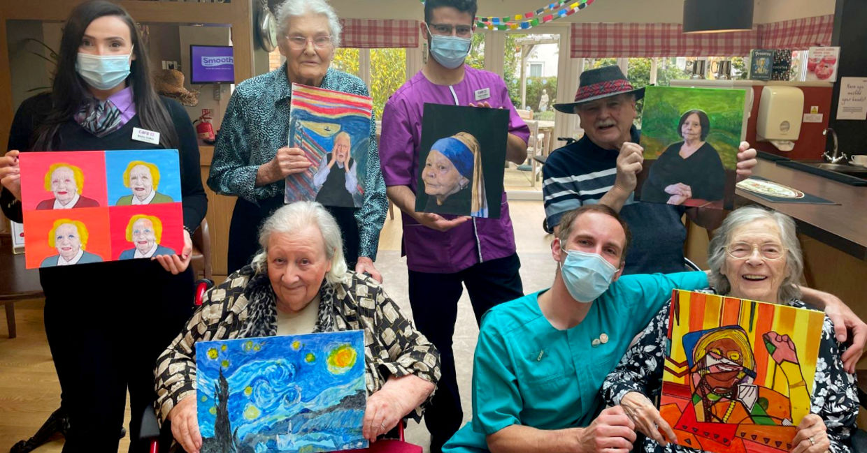 Residents at the Sandfields residential home for seniors pose with some of their art