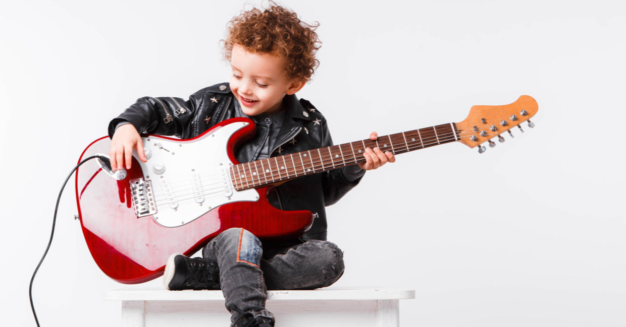 child playing an electric guitar.