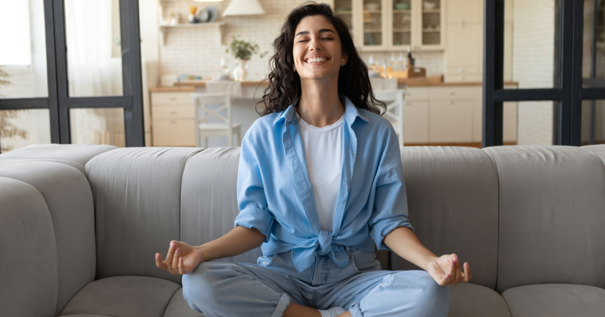 A woman is practicing mindfulness and feeling joyful.