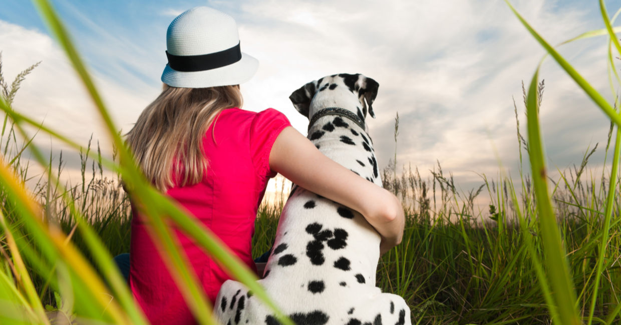 An animal empath lovingly hugs her Dalmatian dog.