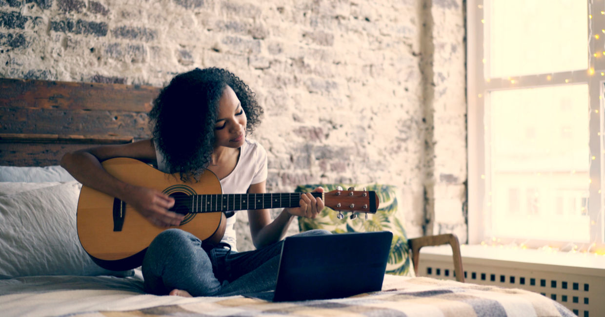 Teenager enjoying playing the guitar