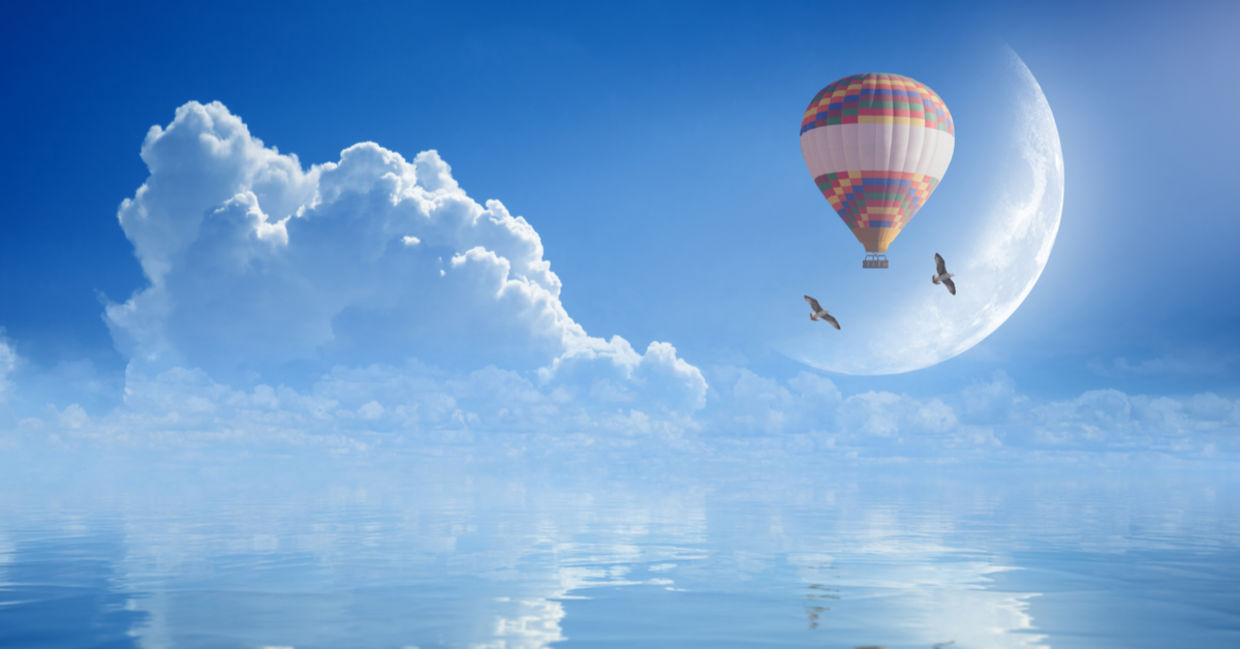 Idyllic image of hot air balloon and birds soaring to signify purpose