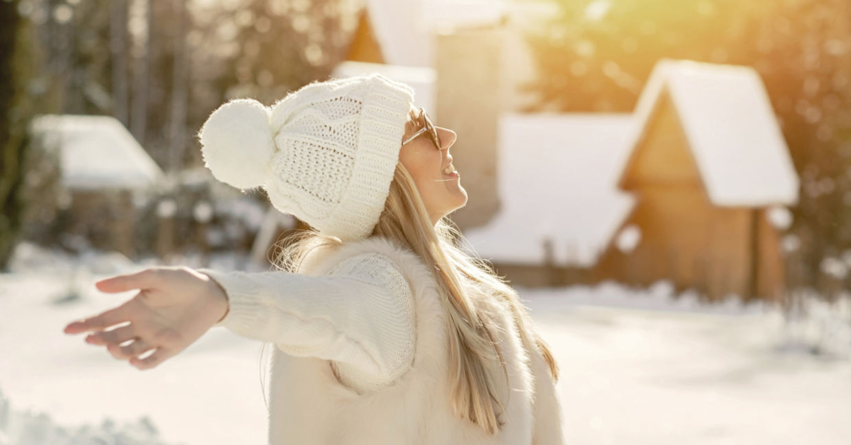 A woman enjoys a moment in the warm winter sun.