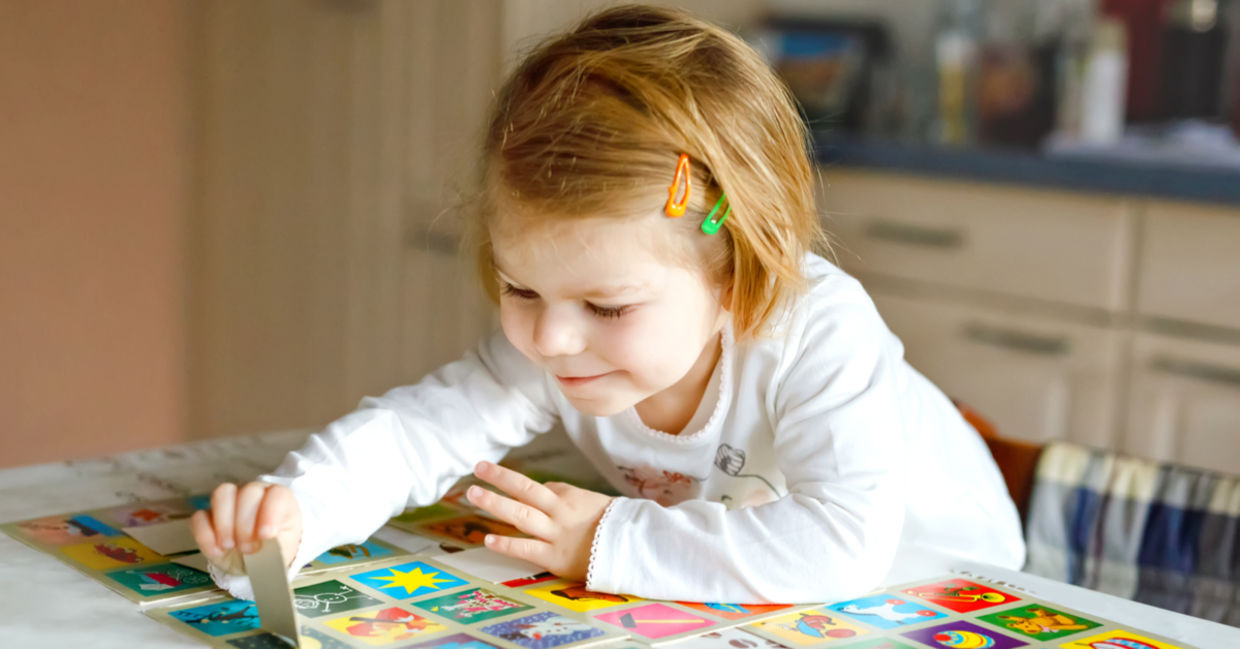 Preschooler playing a memory game.