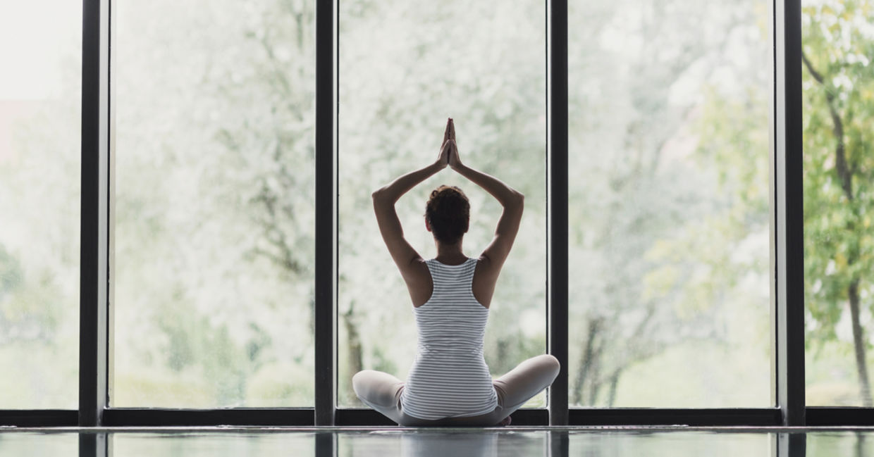 Young woman meditating at home.