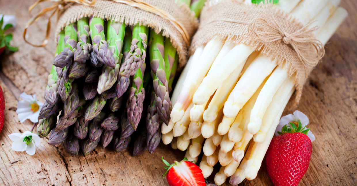 Bunches of fresh green and white asparagus.
