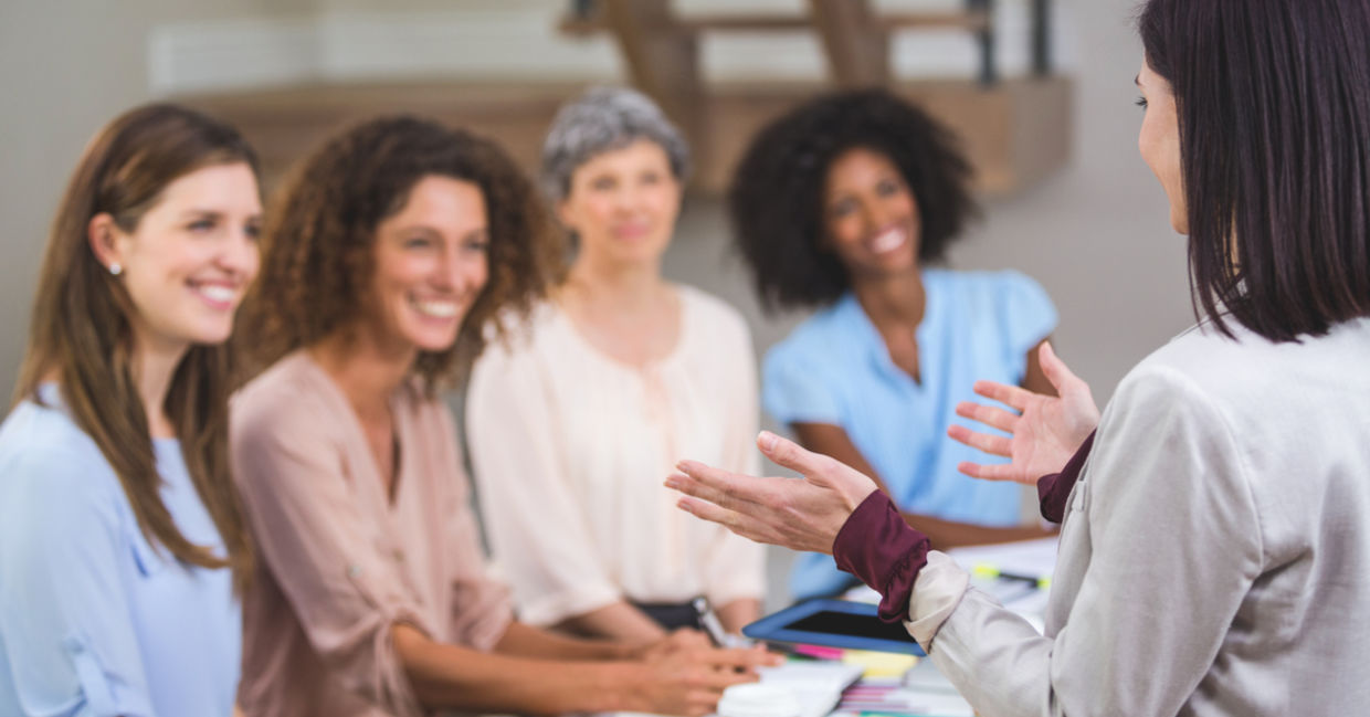 Women presenting to her female colleagues at work.