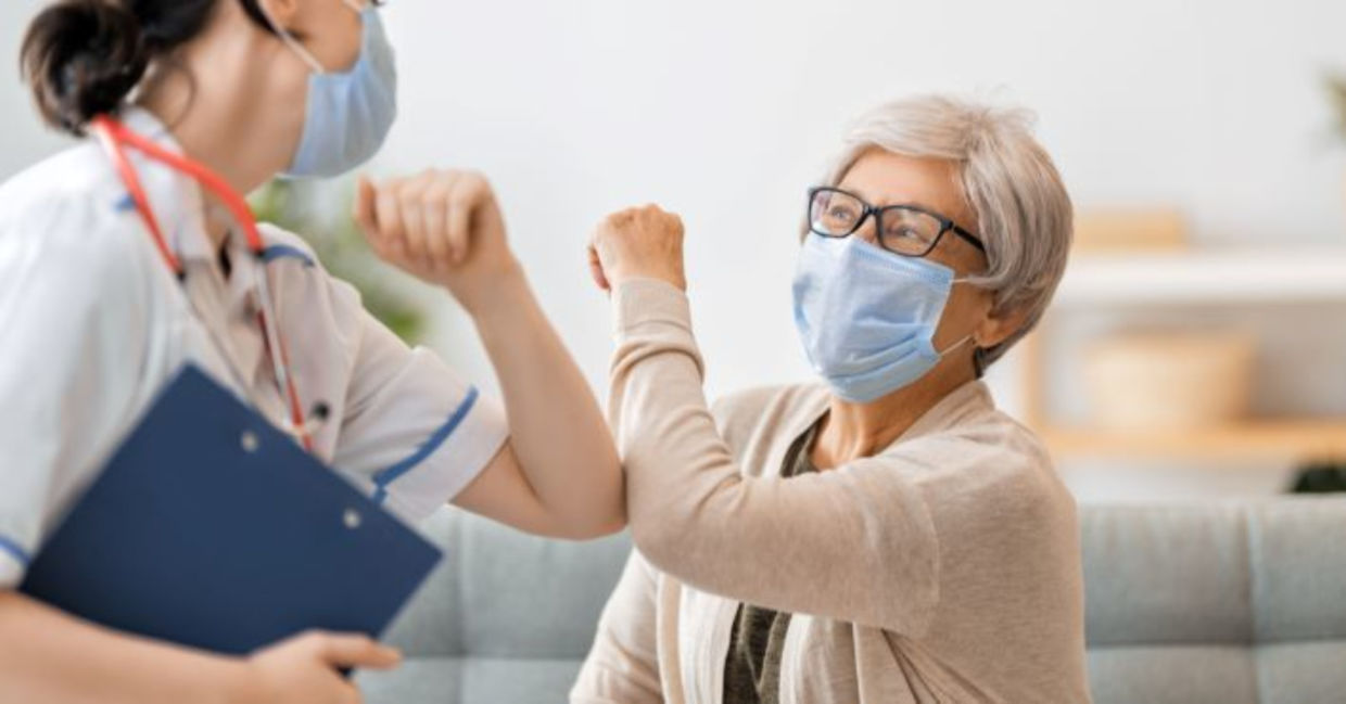 A doctor helps a woman during the COVID 19 pandemic.