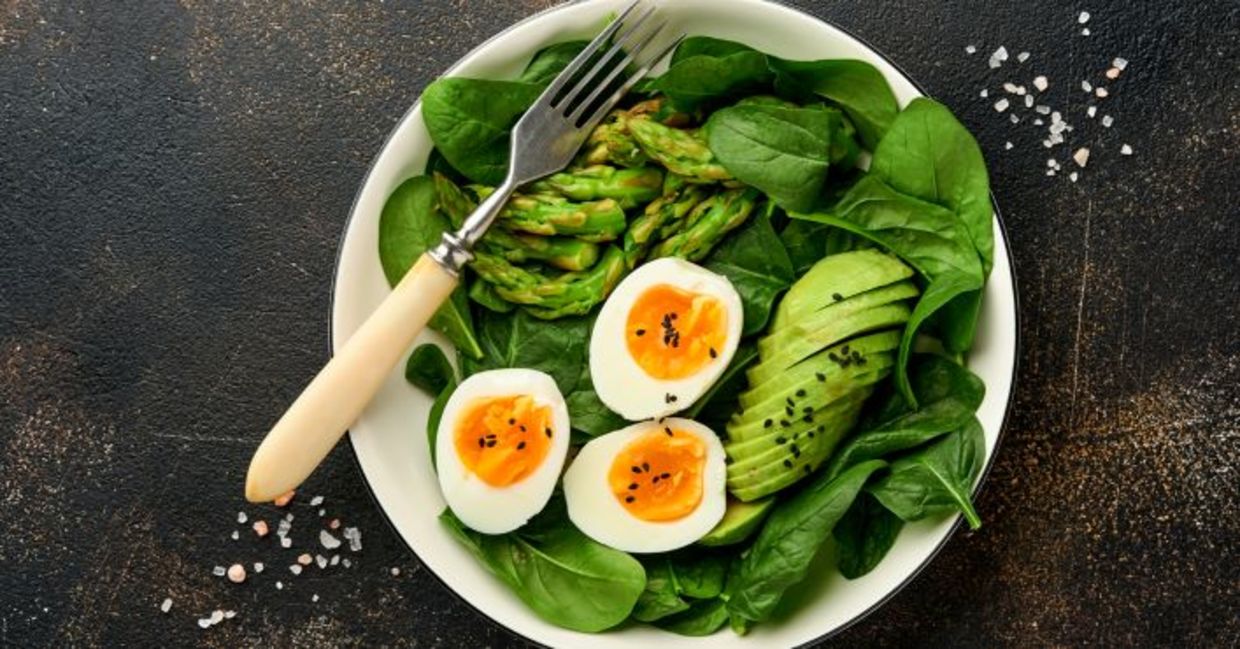 Fresh salad with asparagus, avocado, and spinach.