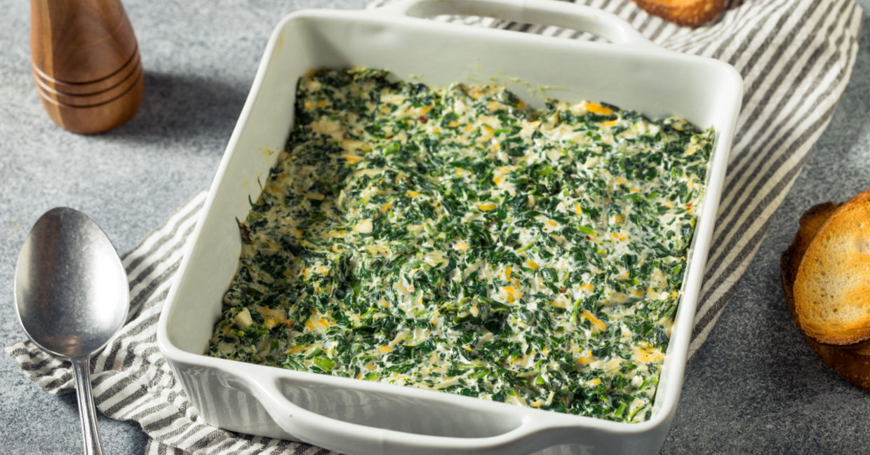 Creamy baked spinach dip in a casserole dish.