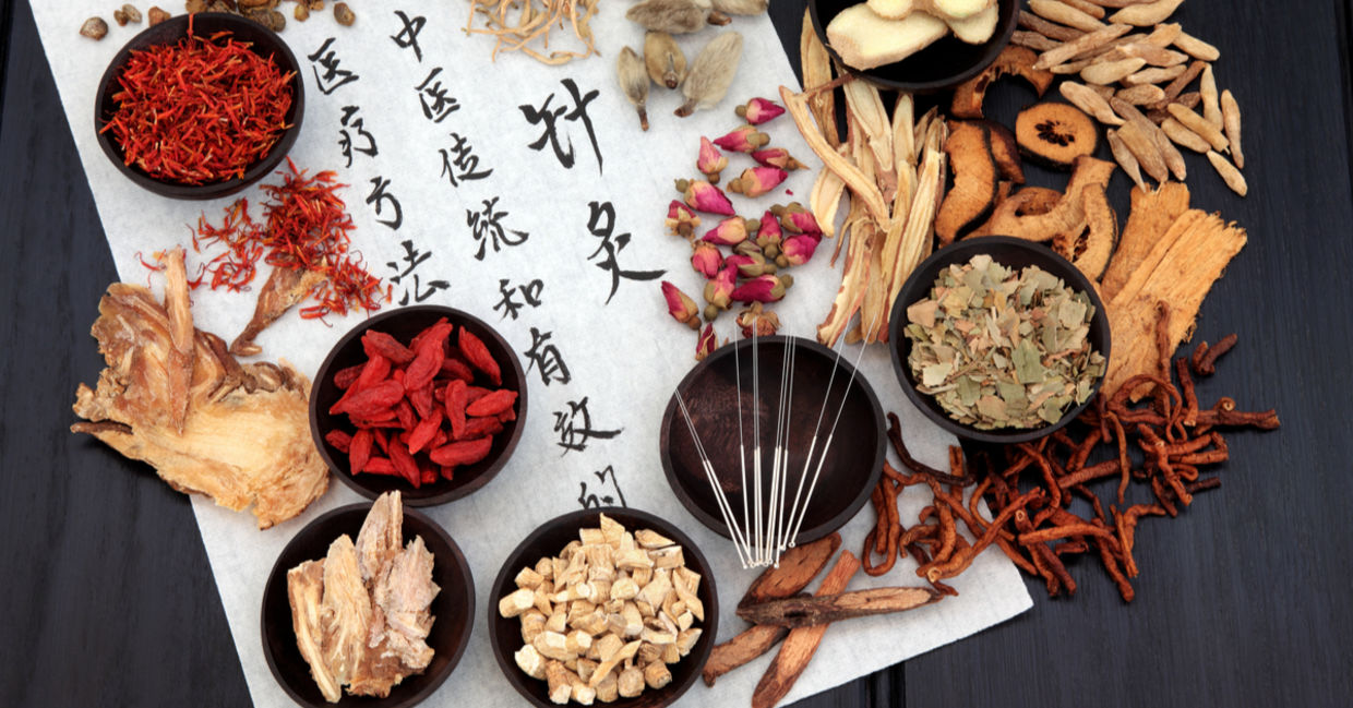 Traditional Chinese medicine herbs, and acupuncture needles.
