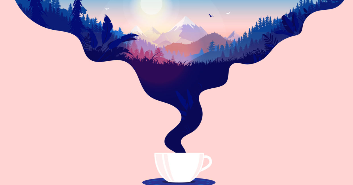Coffee cup with steam and a beautiful sunrise in a landscape with forest, mountains and blue sky.