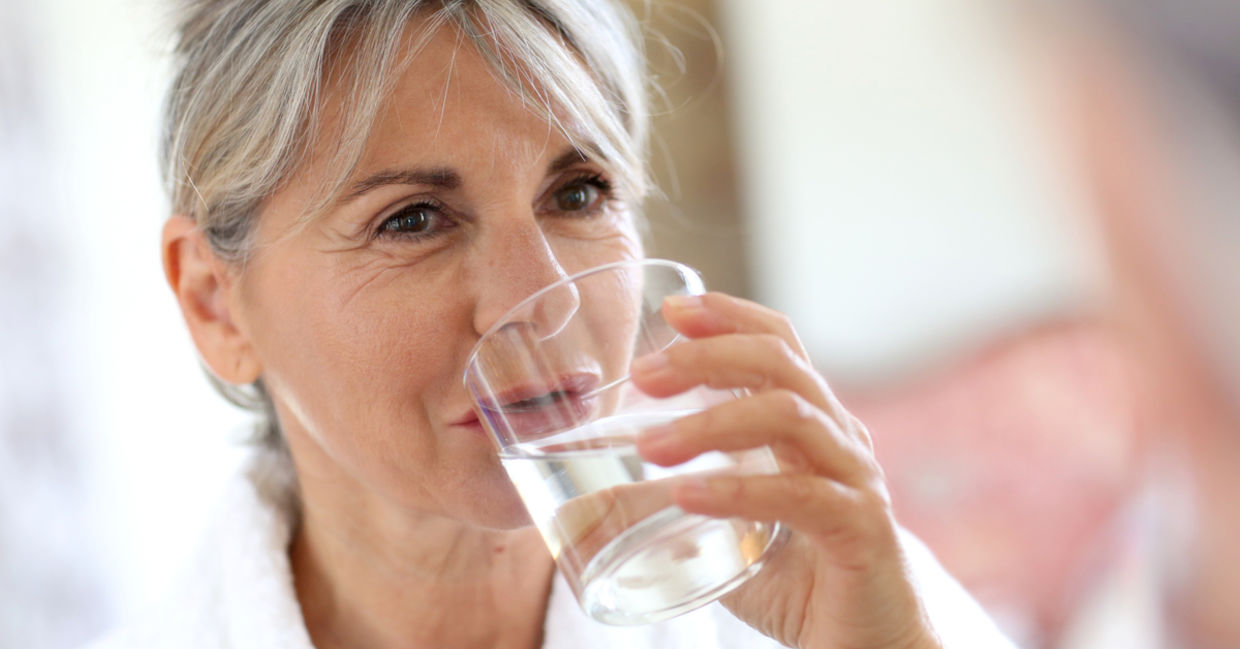 Woman drinking water in the morning.