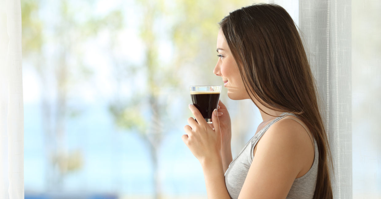A pensive woman drinking coffee.