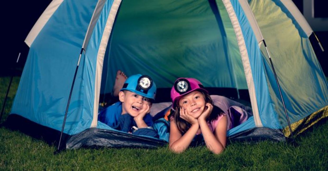 Kids camping in their backyard.