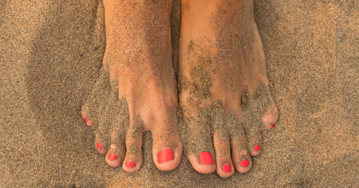 Feet in the sand get a massage and exfoliation.