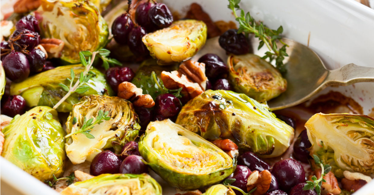 Roasted brussels sprouts served with grapes and nuts.