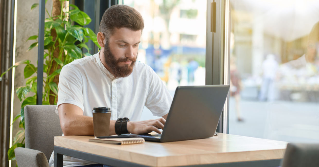 A man works with a laptop.