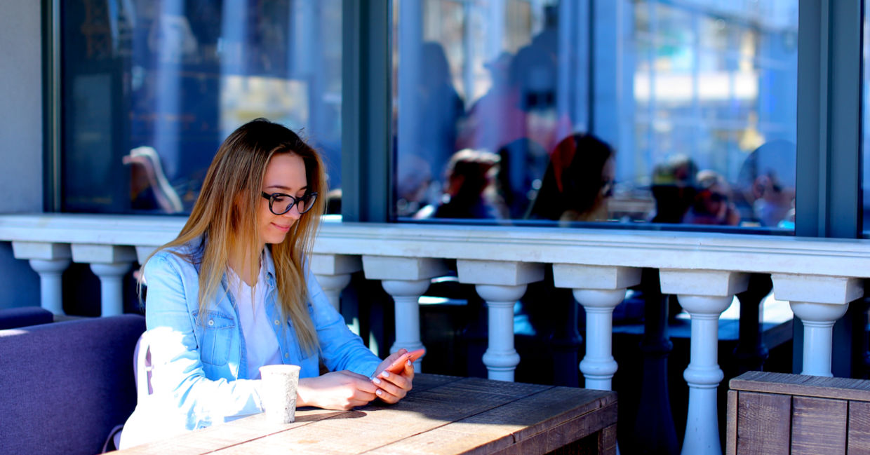 Young woman using her smartphone to boost productivity.