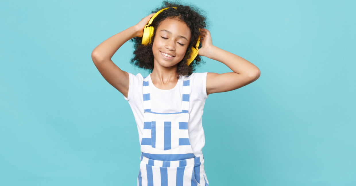 Cute kid enjoying music.