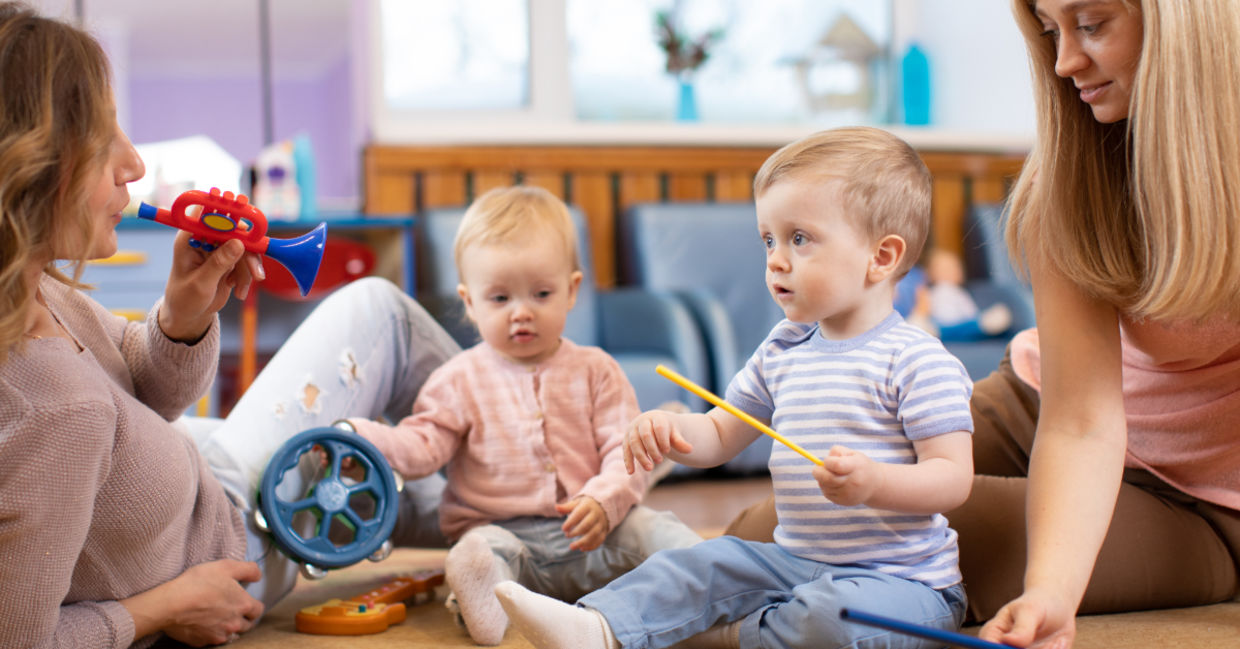 Preschoolers learning music with their parents.