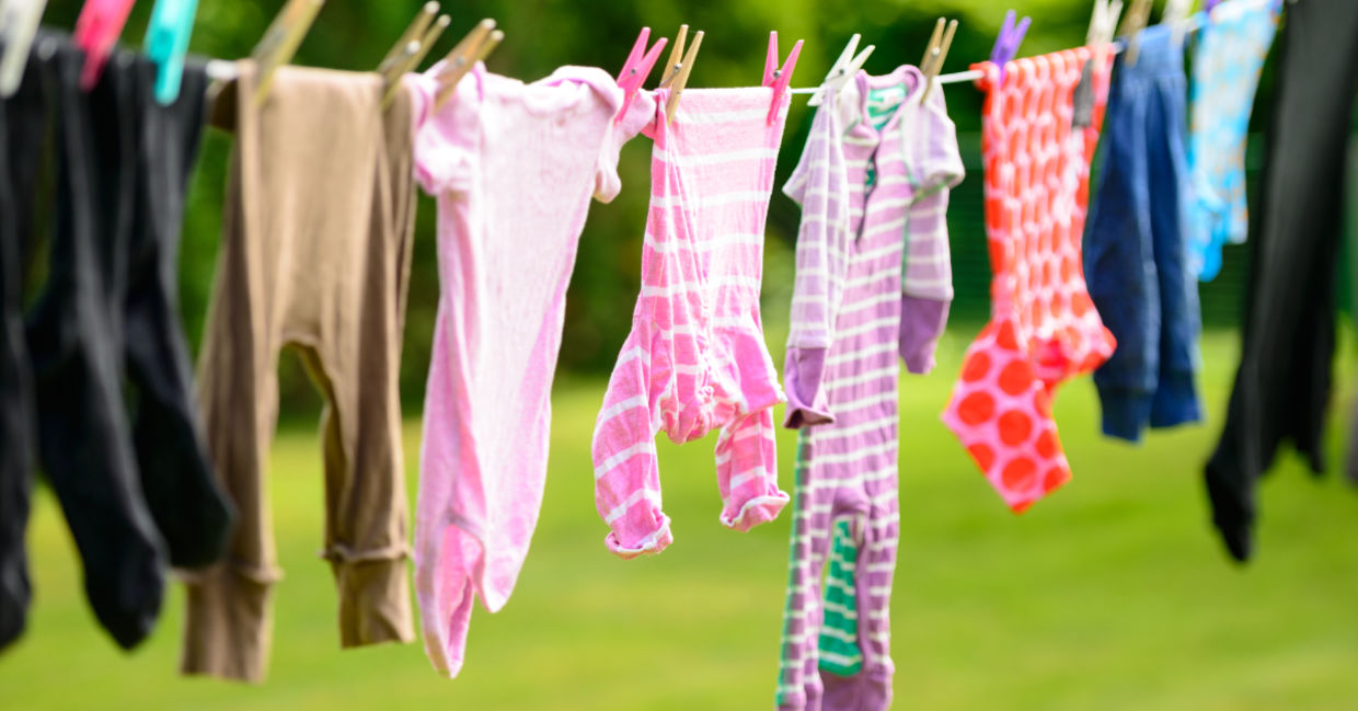 Hanging clothes on a line to dry outside.