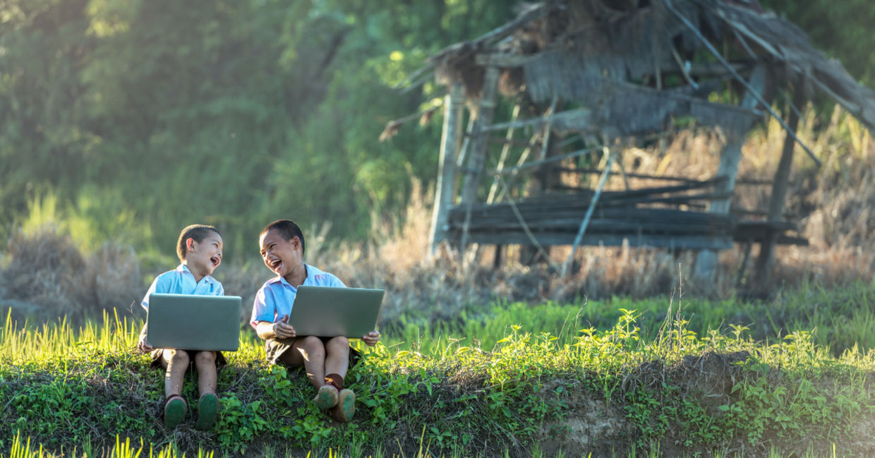 Two boys studying with a laptop.