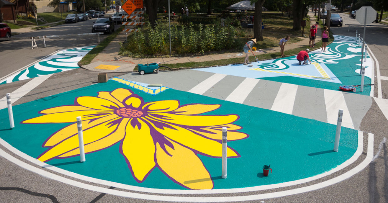 Artists and volunteers paint a colorful intersection in Pittsburgh, PA.