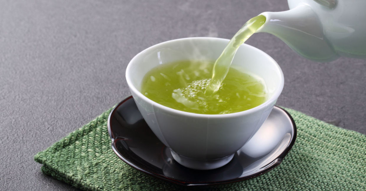 A cup of steaming hot green tea.