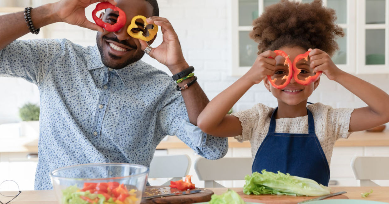 A father and daughter enjoy making a tryptophan-rich salad together.