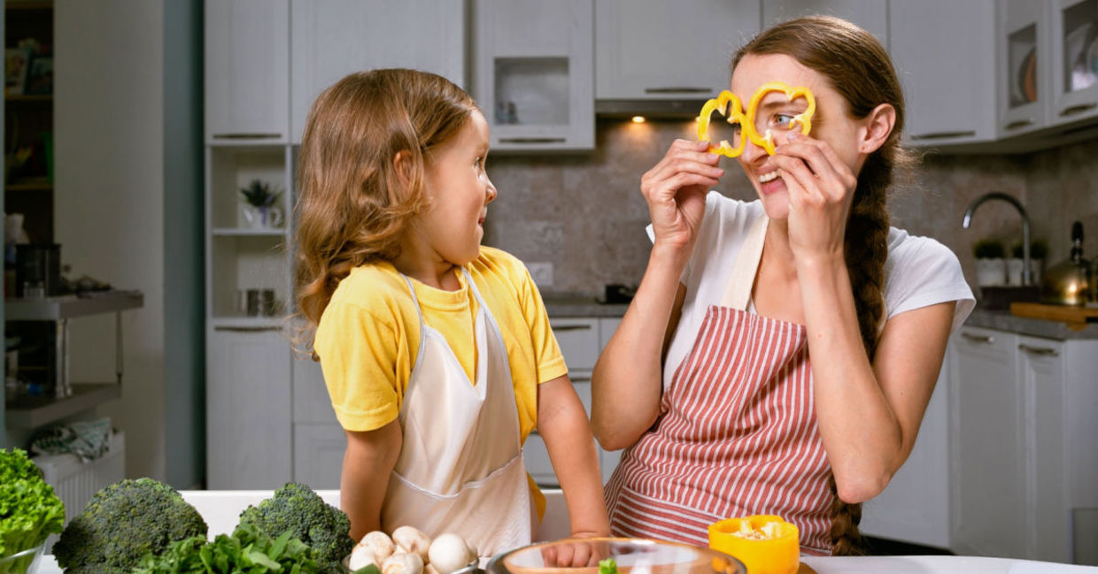 A mother and daughter have fun preparing vegetables, an important food in a psychobiotic diet.