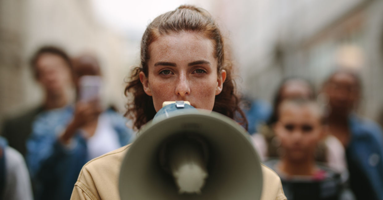 A woman protesting with a megaphone.