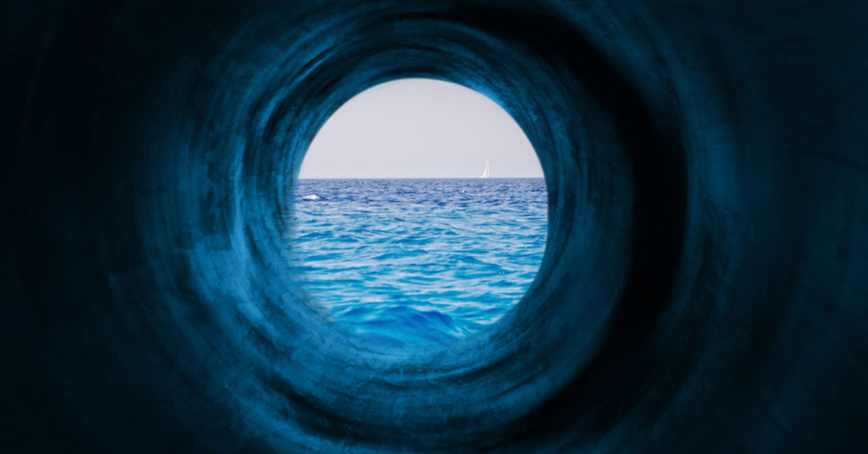 Blue tunnel to a calm sea symbolizing the way to tranquility and goals.