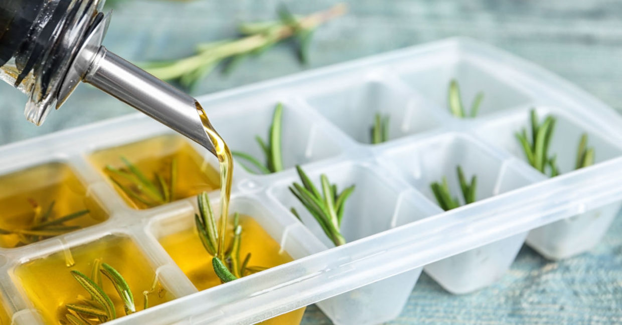 Freezing rosemary in olive oil in an ice cube tray.
